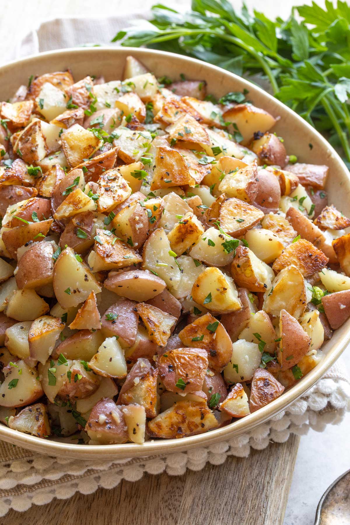 Recipe in yellow serving bowl, sprinkled with parsley.