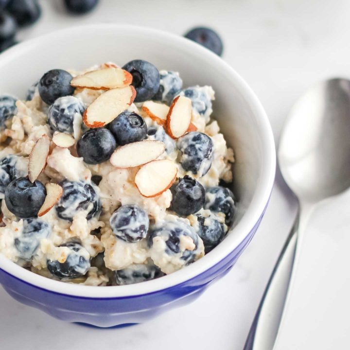 Closeup of the finished recipe in a blue bowl with a spoon resting alongside.