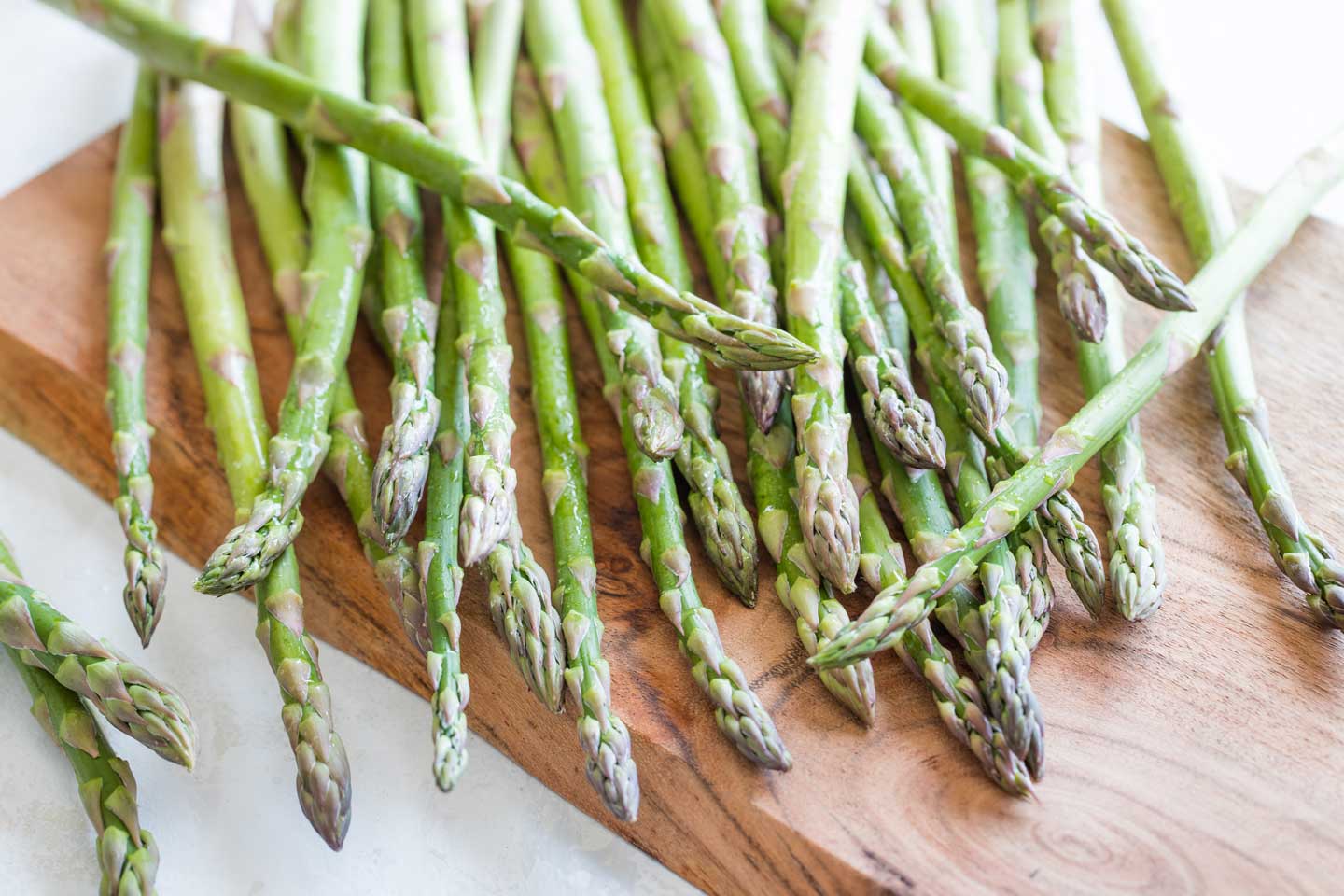 Overhead closeup of really fresh asparagus spears damp with water droplets.