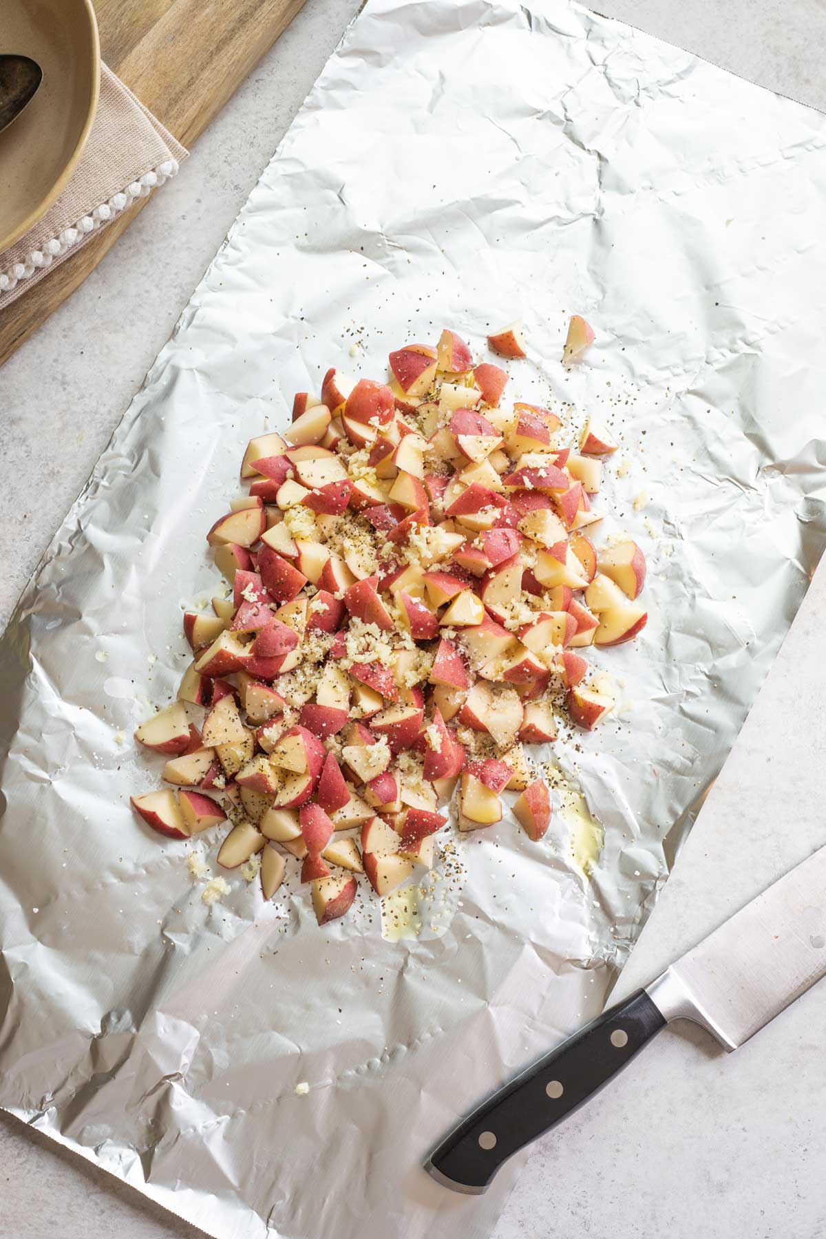 All ingredients on flat sheet of foil with knife alongside.