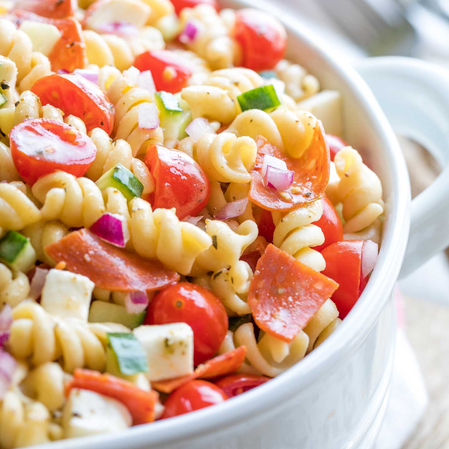 Super closeup shot of the pasta salad recipe, finished and in a serving bowl.