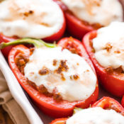 Partial view of six Italian Stuffed Peppers, still in baking dish and ready to serve.