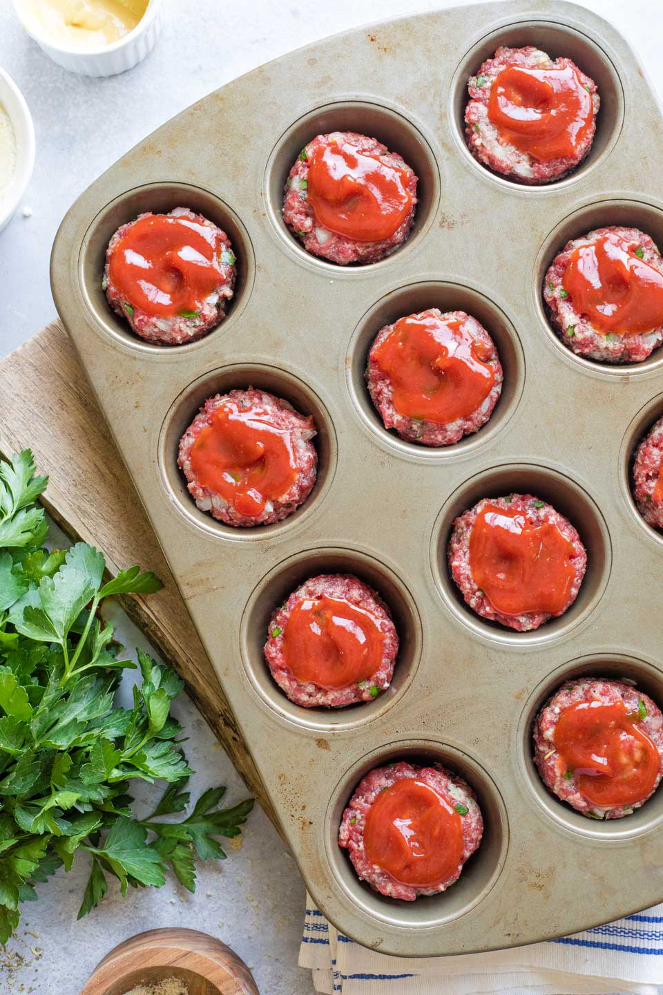 Overhead of full muffin tin before baking.